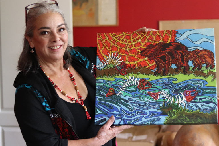 Janine posing with her painting 768x512